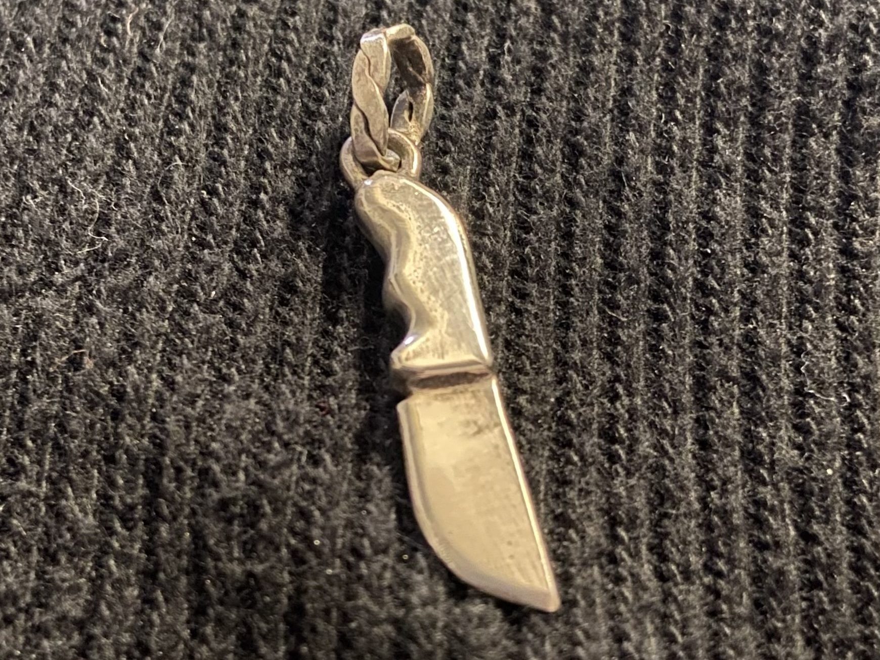 image of a silver fabricated, miniature sterling fruit knife set against a gray backdrop